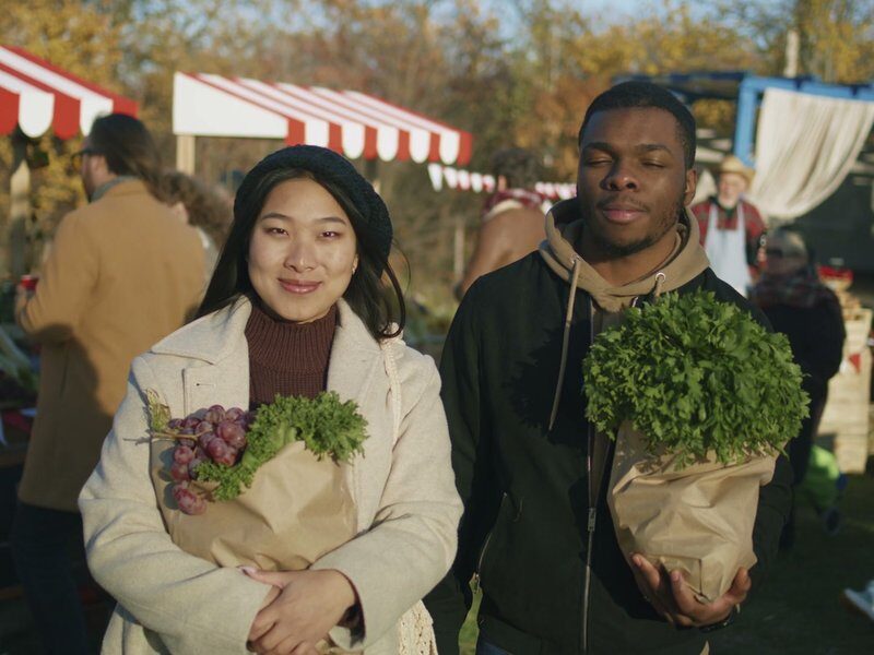 Diverse couple at a farmers market after shopping